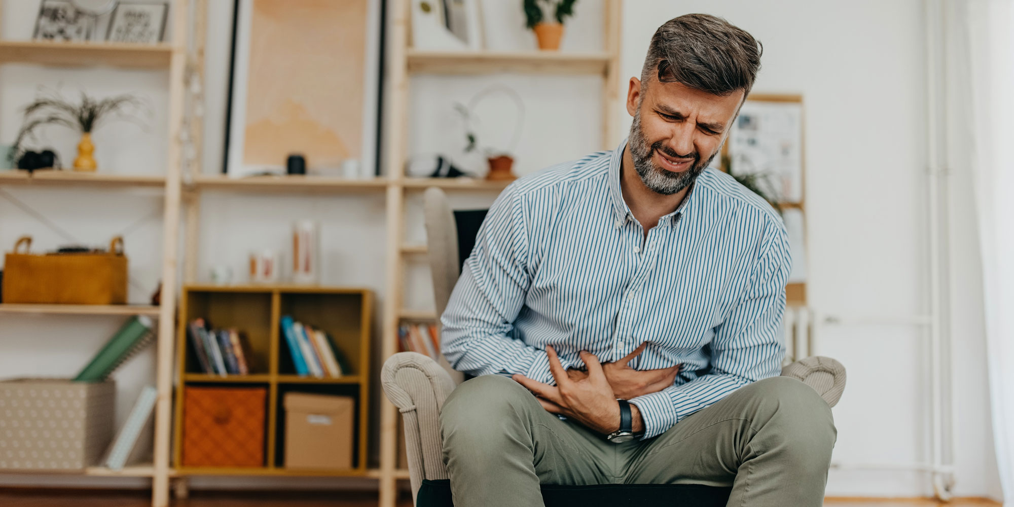 man with stomach cramps 