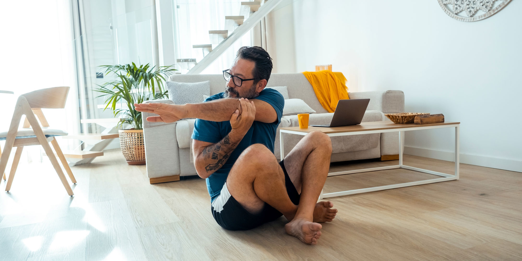 A man stretching at home