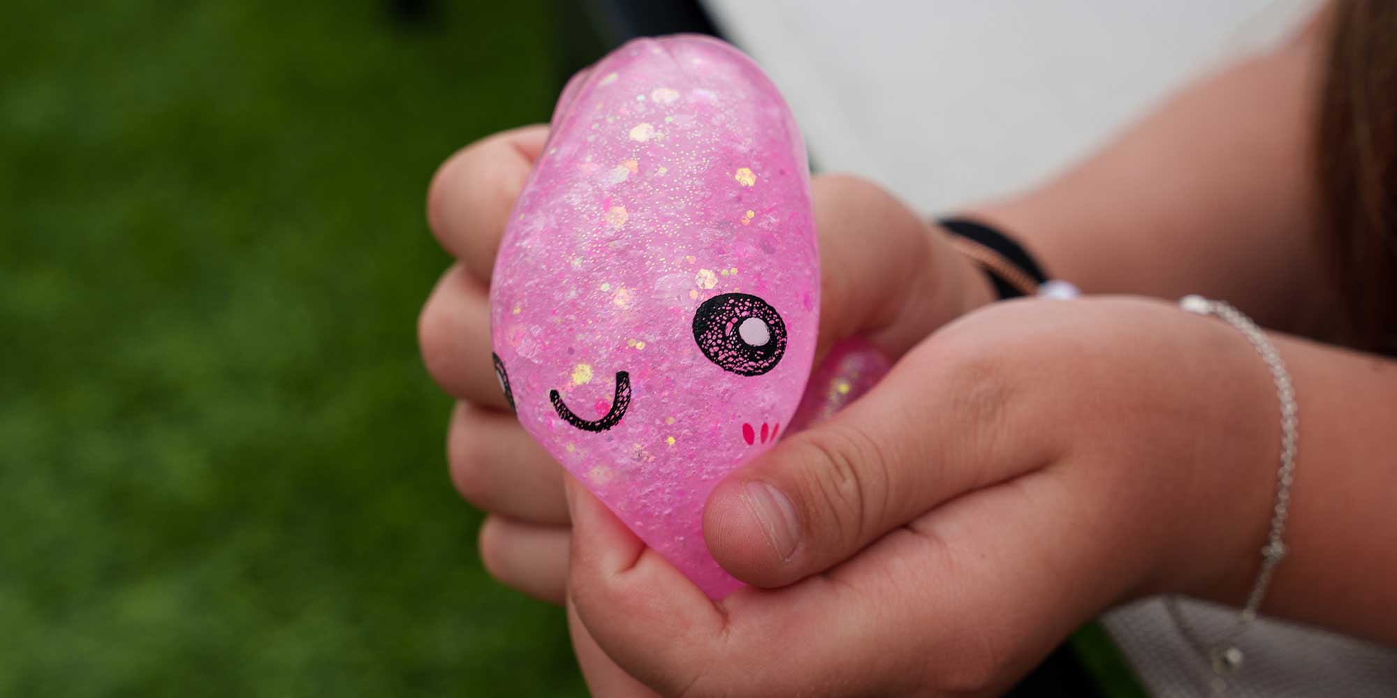 A child squeezing a squishy dumpling toy