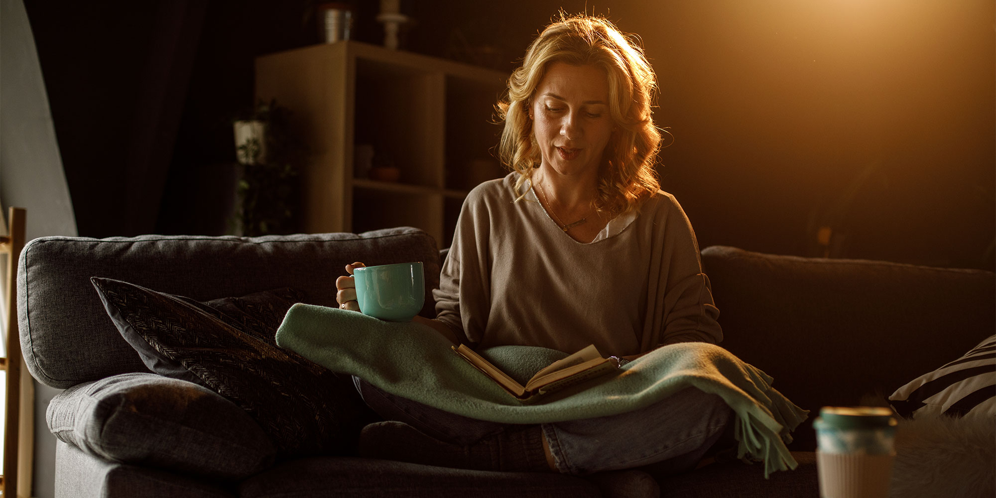A woman reading in low light