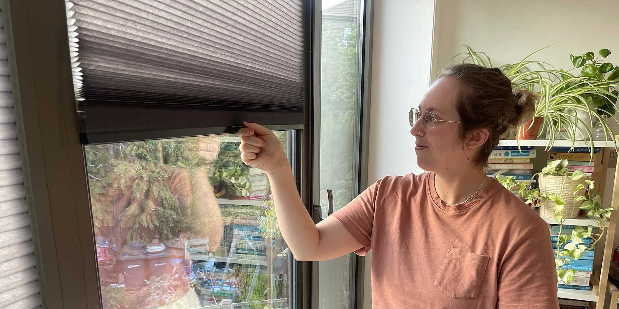 Poppy Gaunt, Which? senior editor, pictured with her stick-on blinds