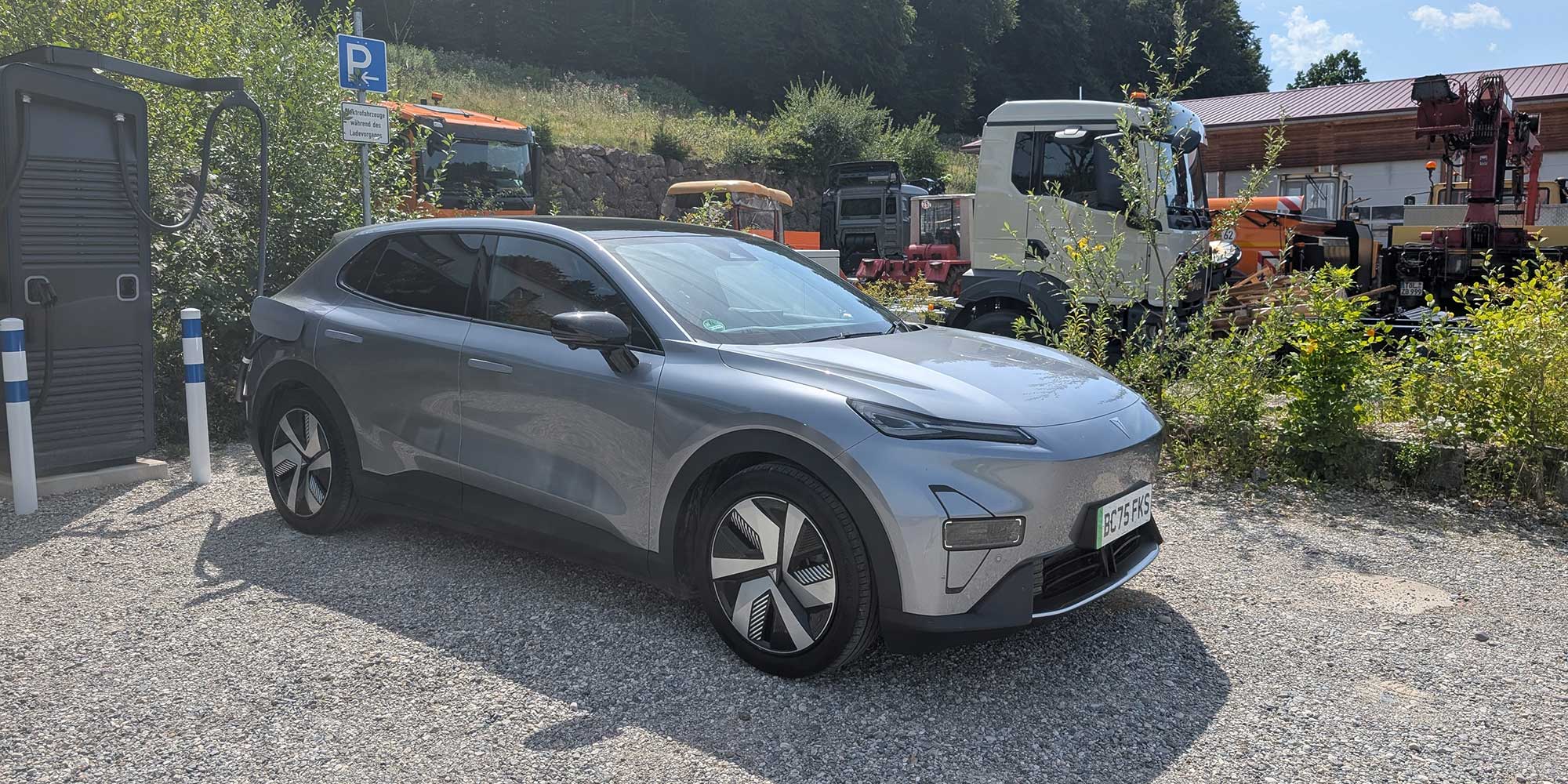 Changan Deepal S05 electric car at a remote charging station, with farm machinary in the background
