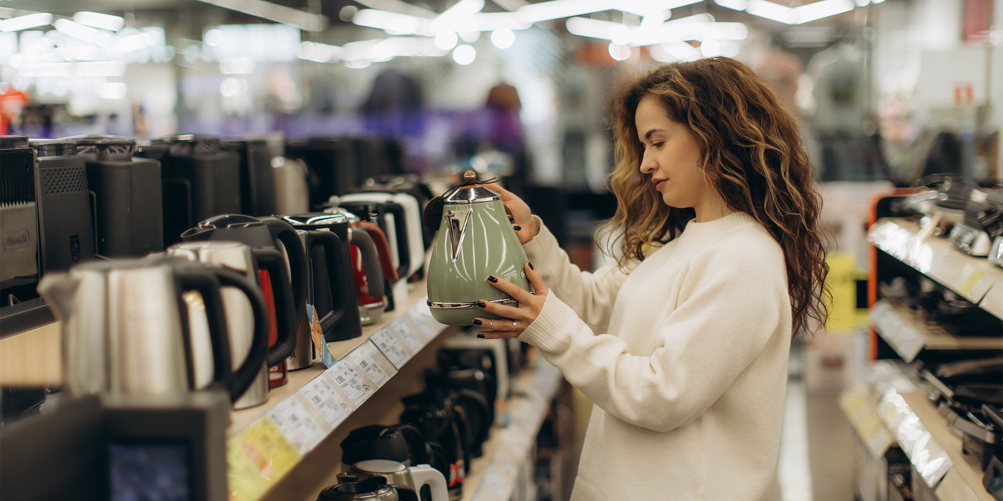Woman shopping for a new kettle