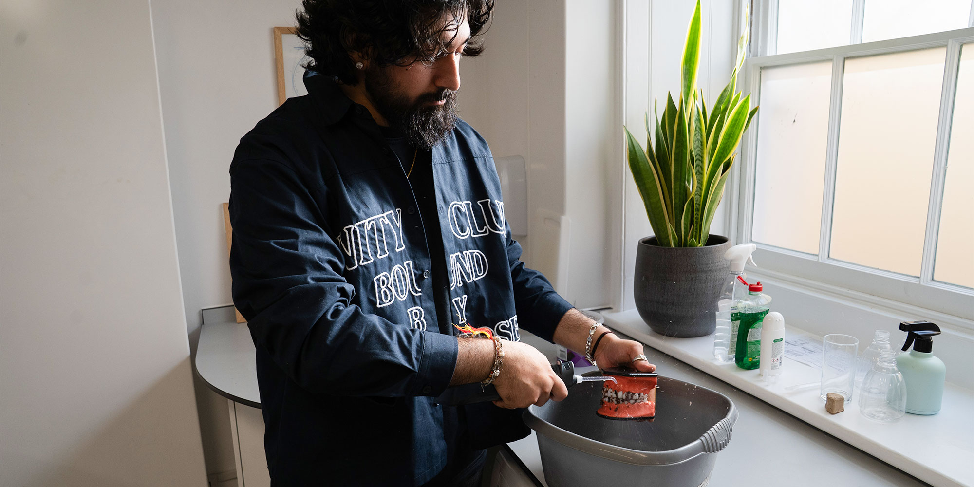 Our water flosser expert cleaning food bits from a dental model