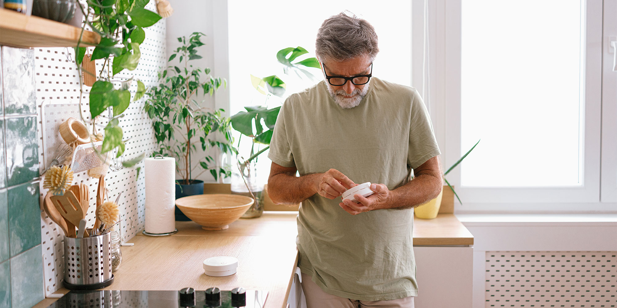 Man changing the batteries on a CO alarm