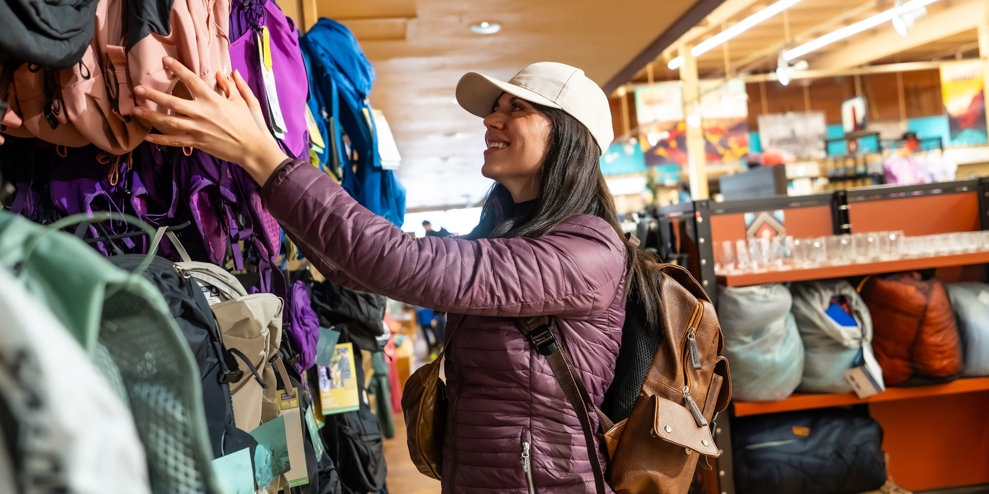 A woman in a shop browsing outdoor brands