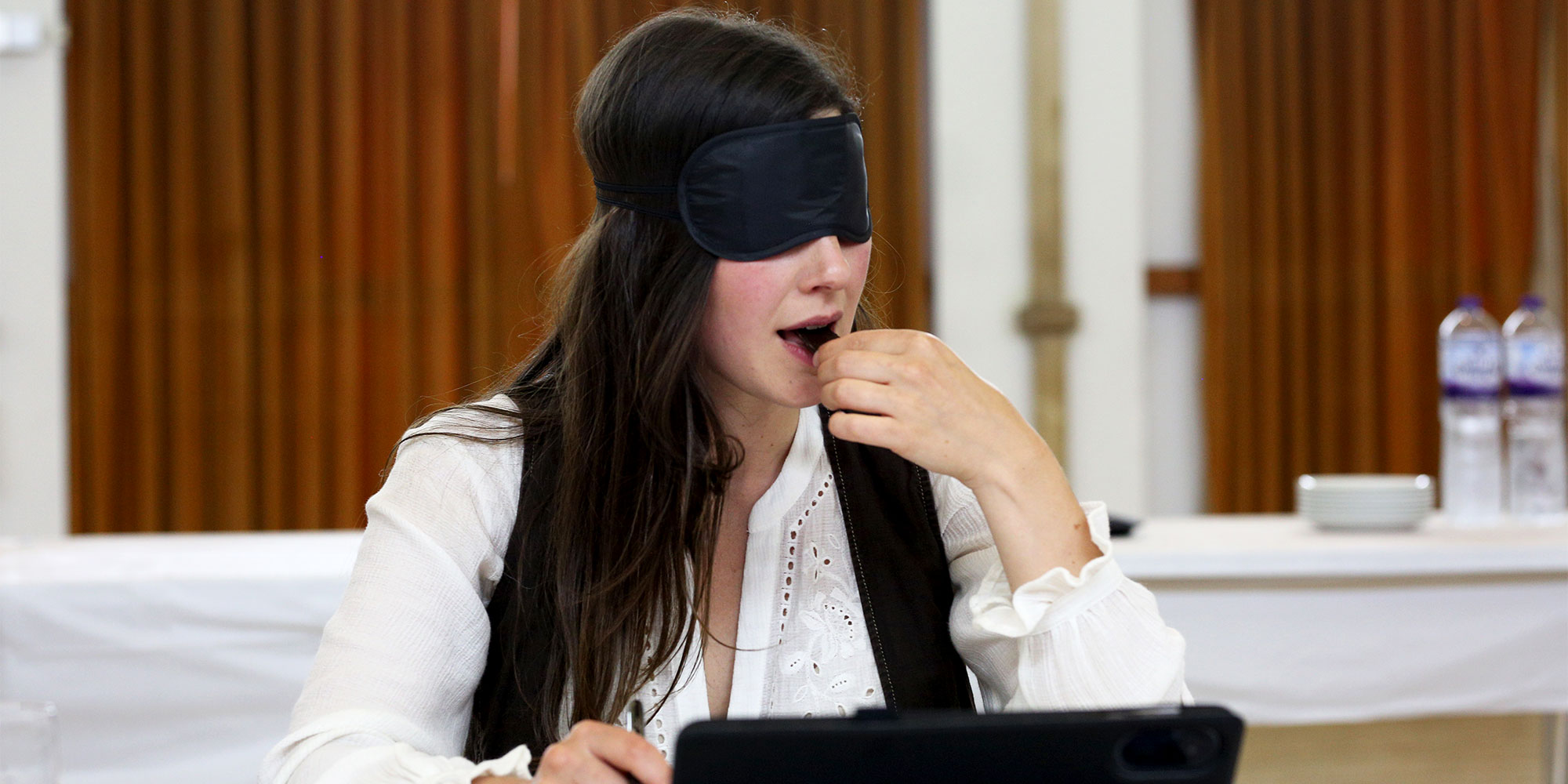 Chocolatier Gabriella Cugno tastes a square of chocolate wearing a blindfold for our dark chocolate taste test