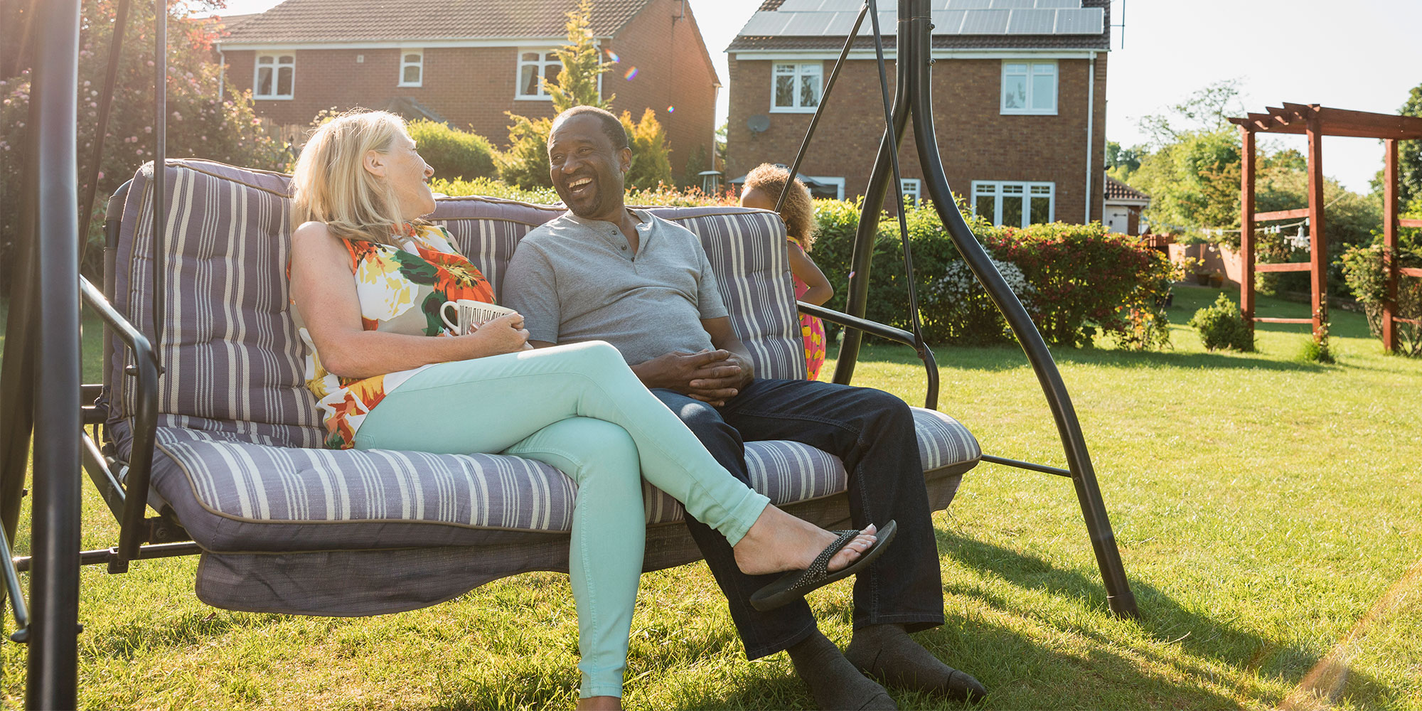 mid life couple relaxing on chair in the garden