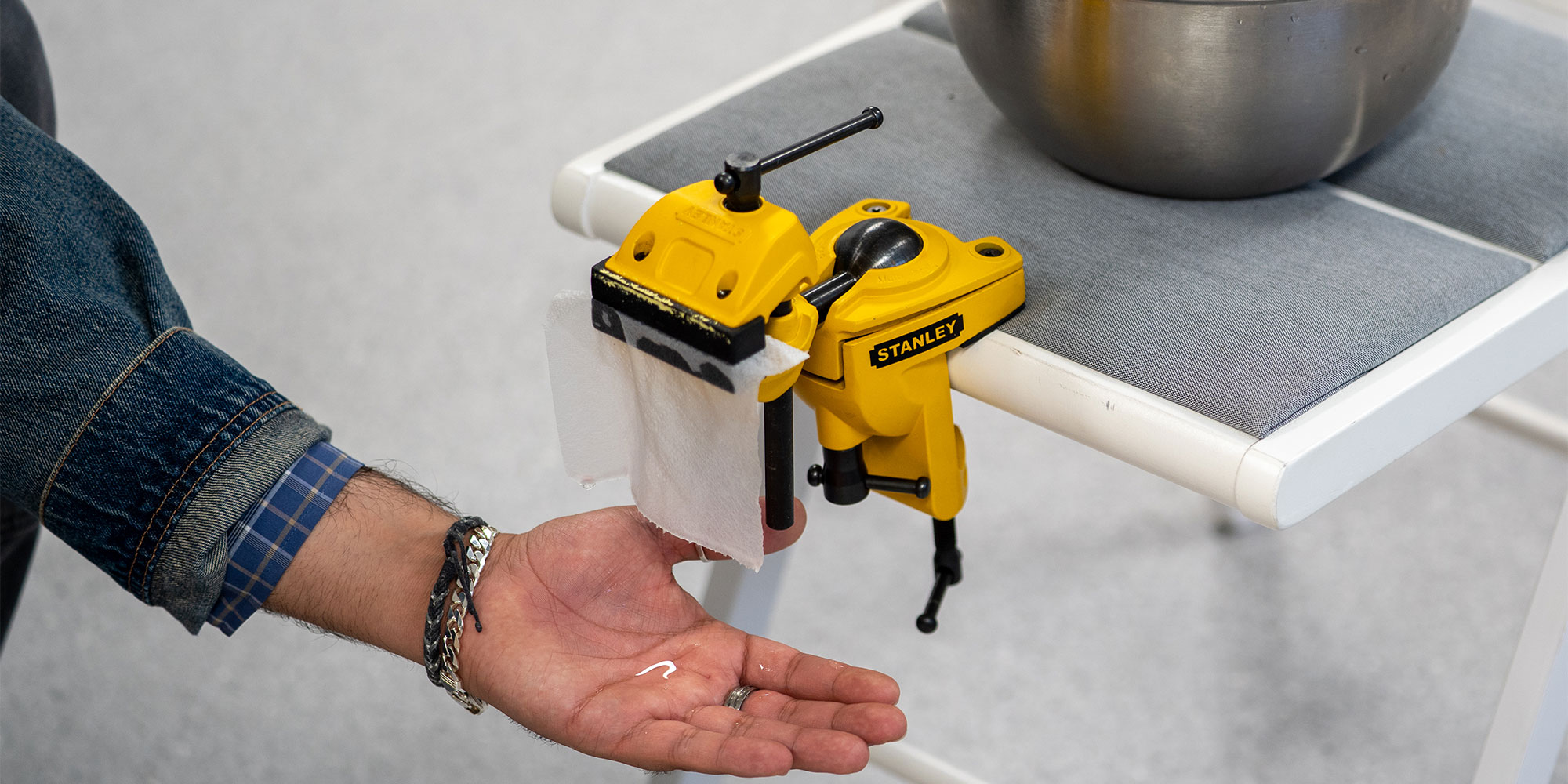 A sheet of roll hanging from a vice dripping with water