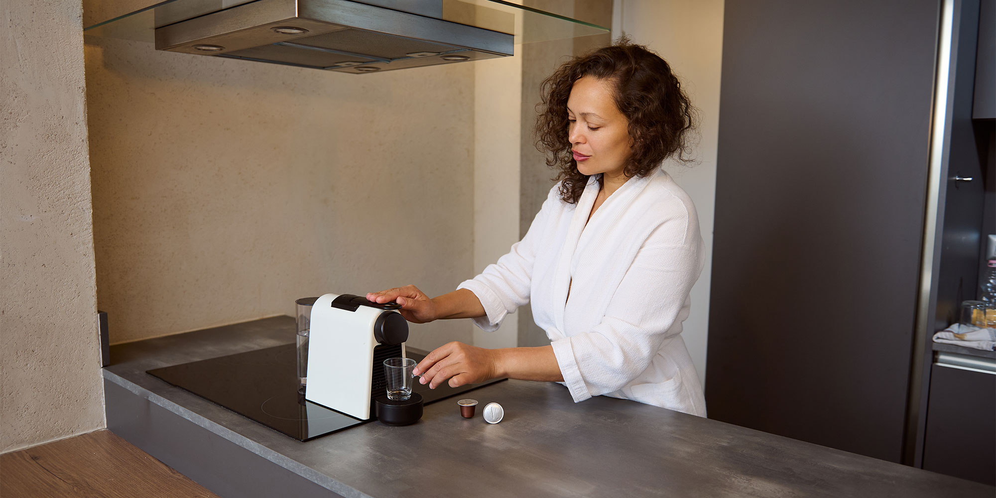 Woman using a pod coffee machine