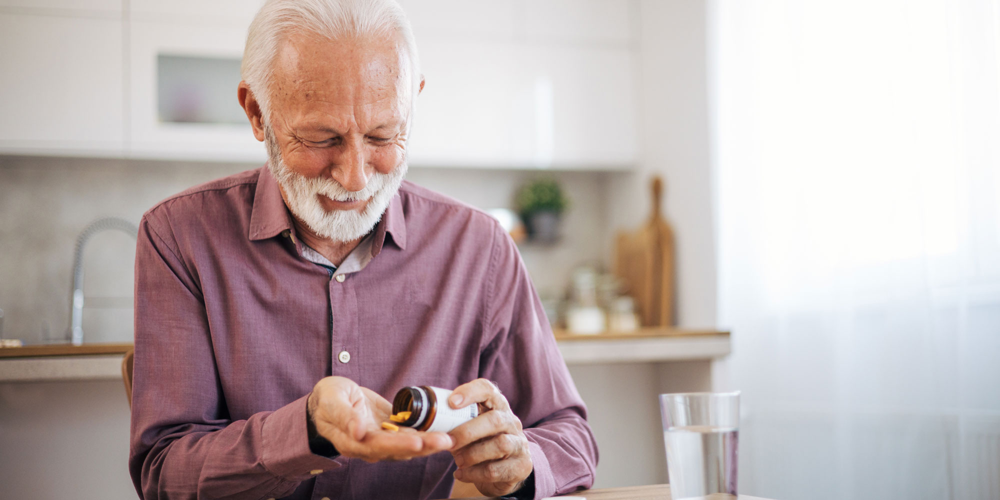 A man looking very happy about taking his daily supplement