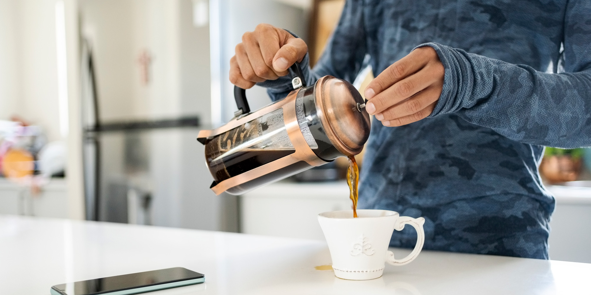 Someone pouring coffee from a cafetiere