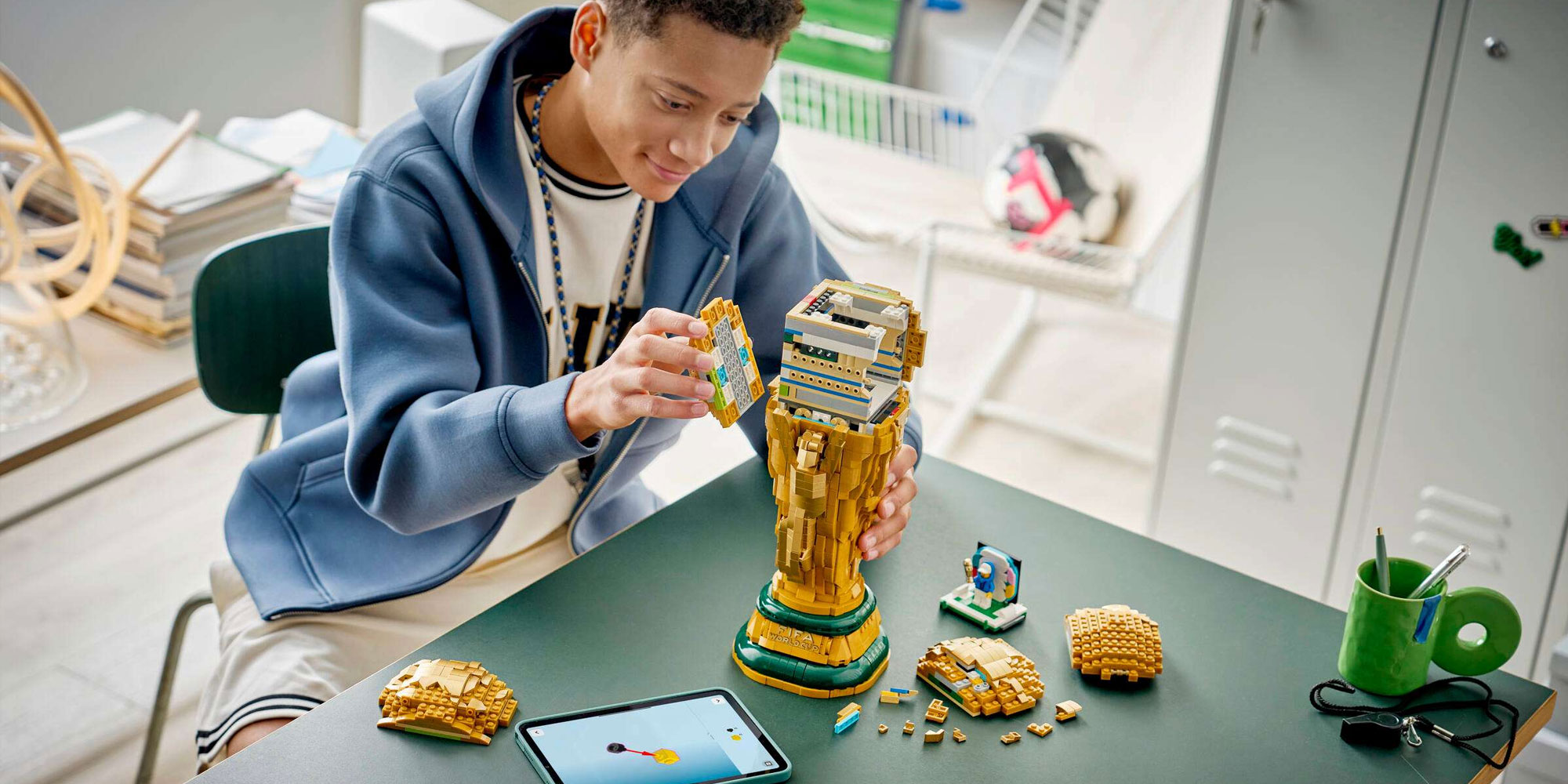 Someone building the Lego FIFA trophy