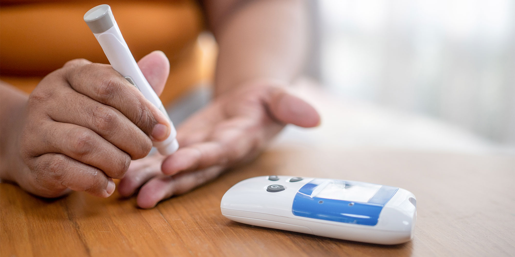 A woman taking a blood sample for a cholesterol test
