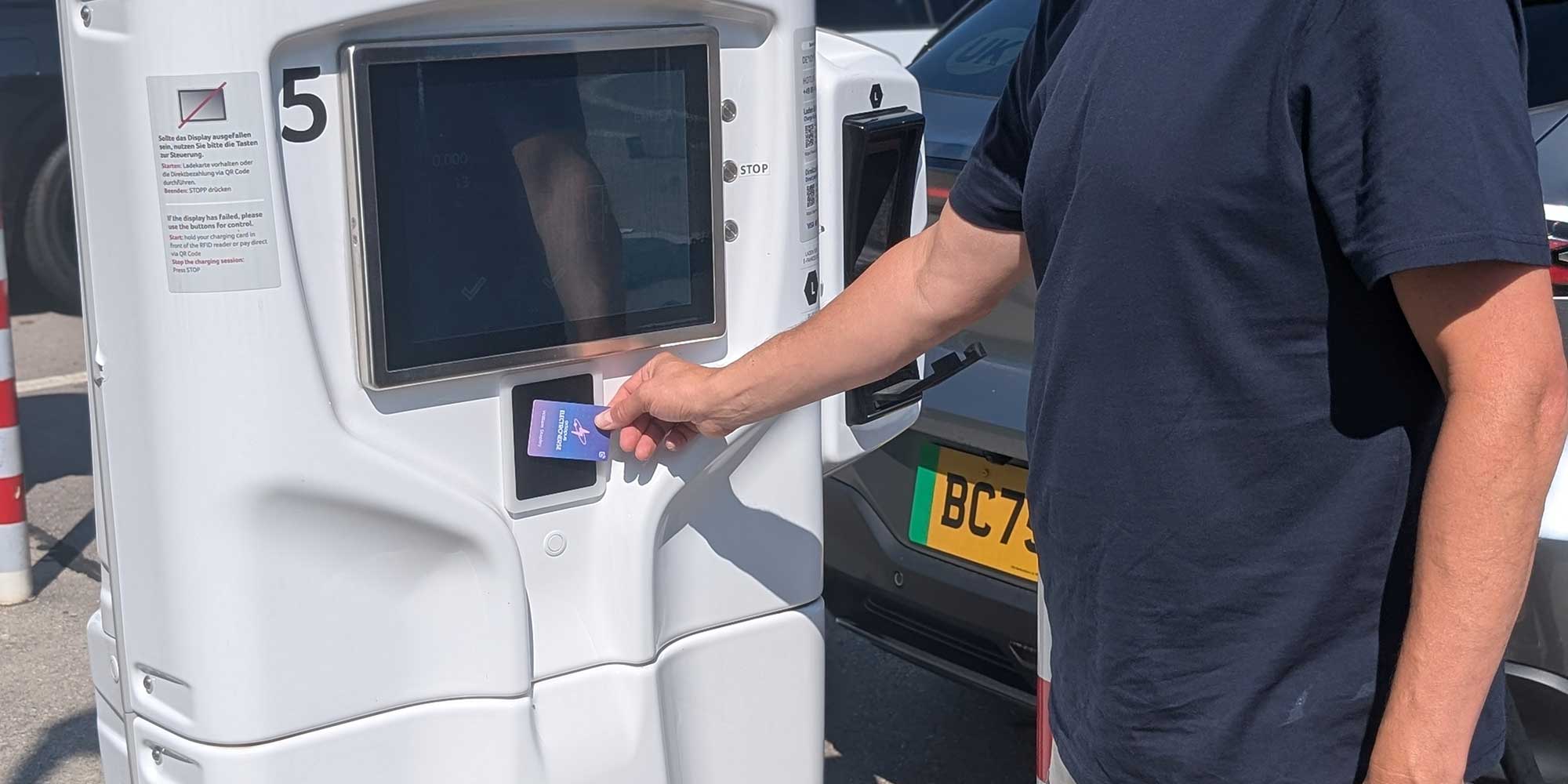 Person using an Electroverse charge card on white public charge point