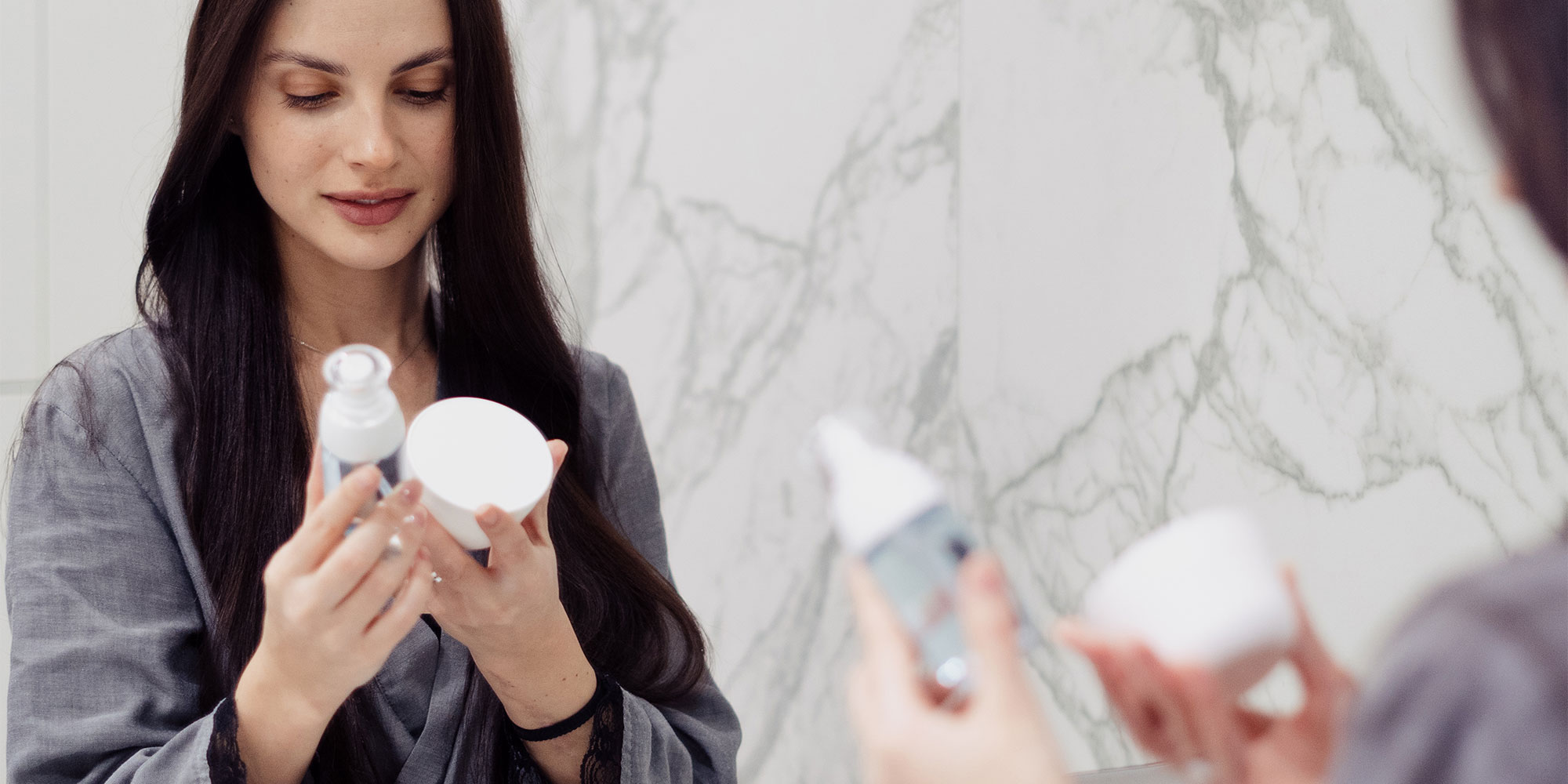 Woman checking expiration dates on beauty products