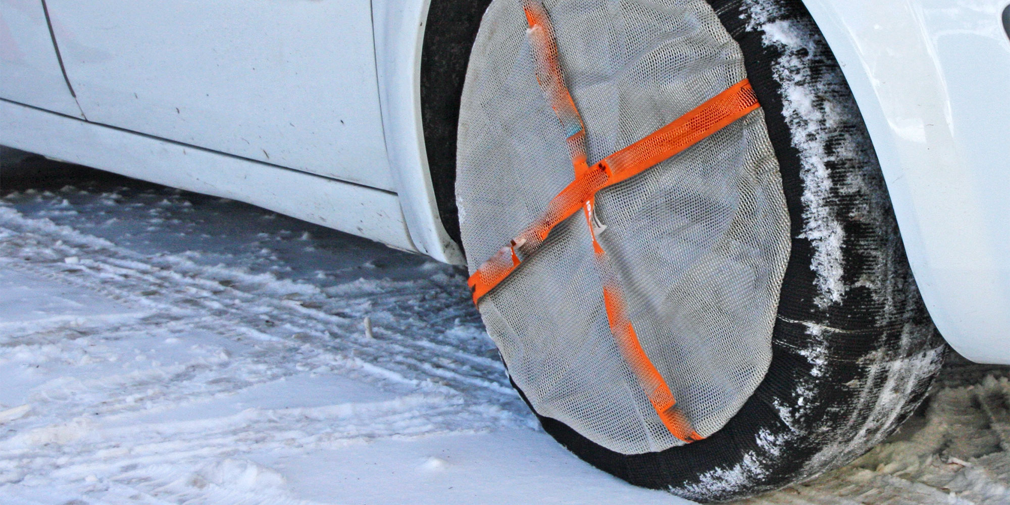 Snow socks on a car in snowy conditions