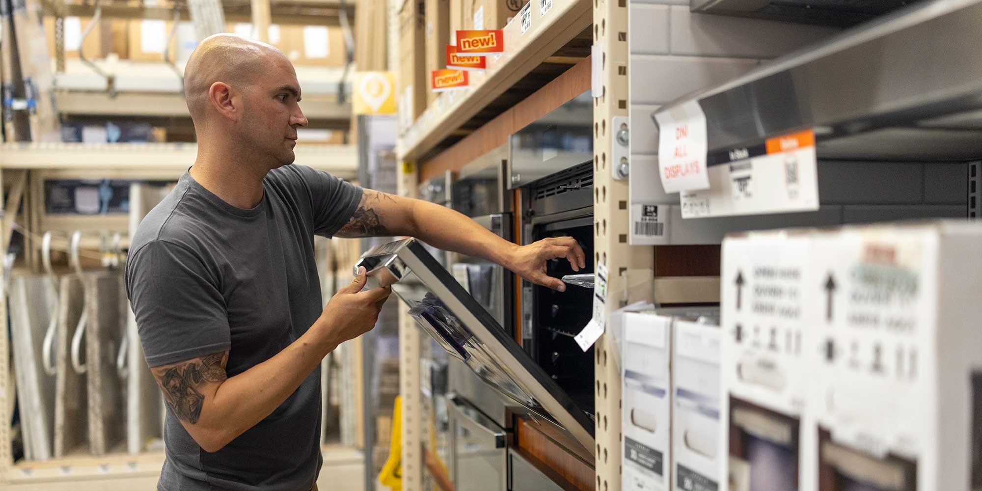 Man looking at an oven in a store
