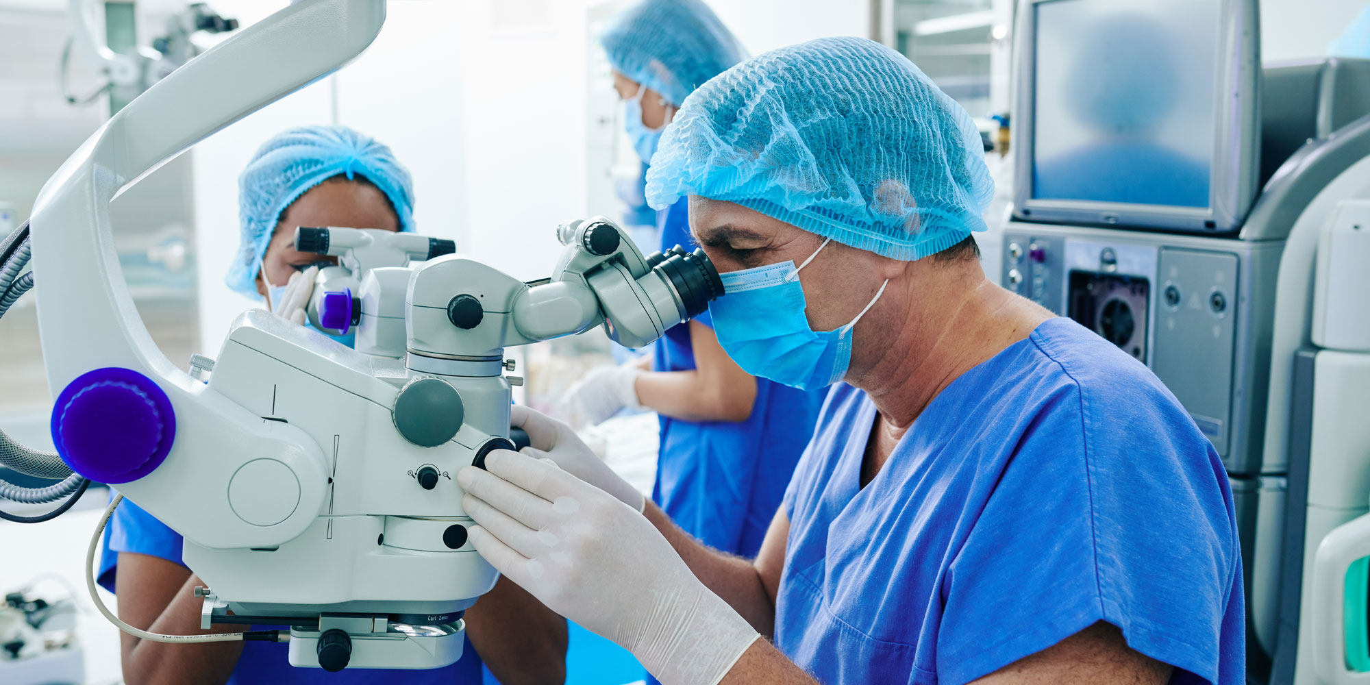A medical professional looking through a specialist piece of equipment