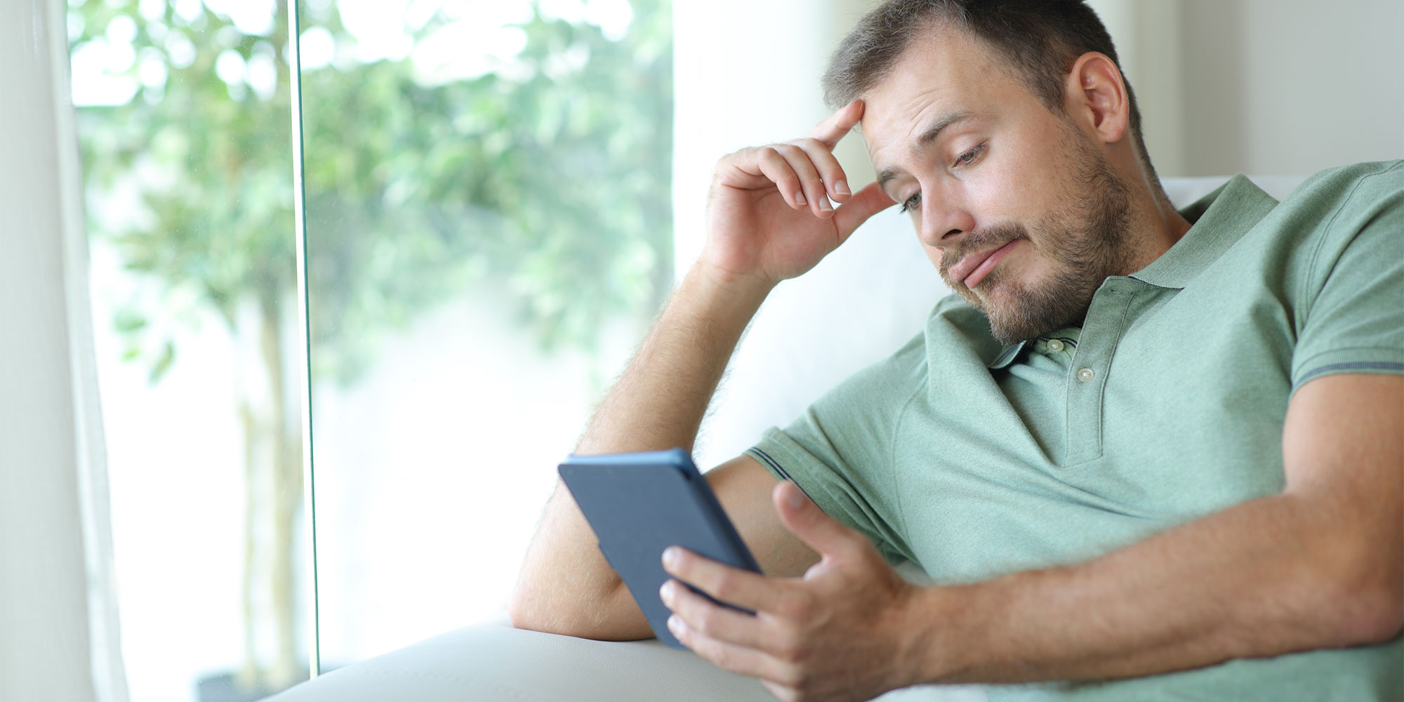 Man reading a Kindle