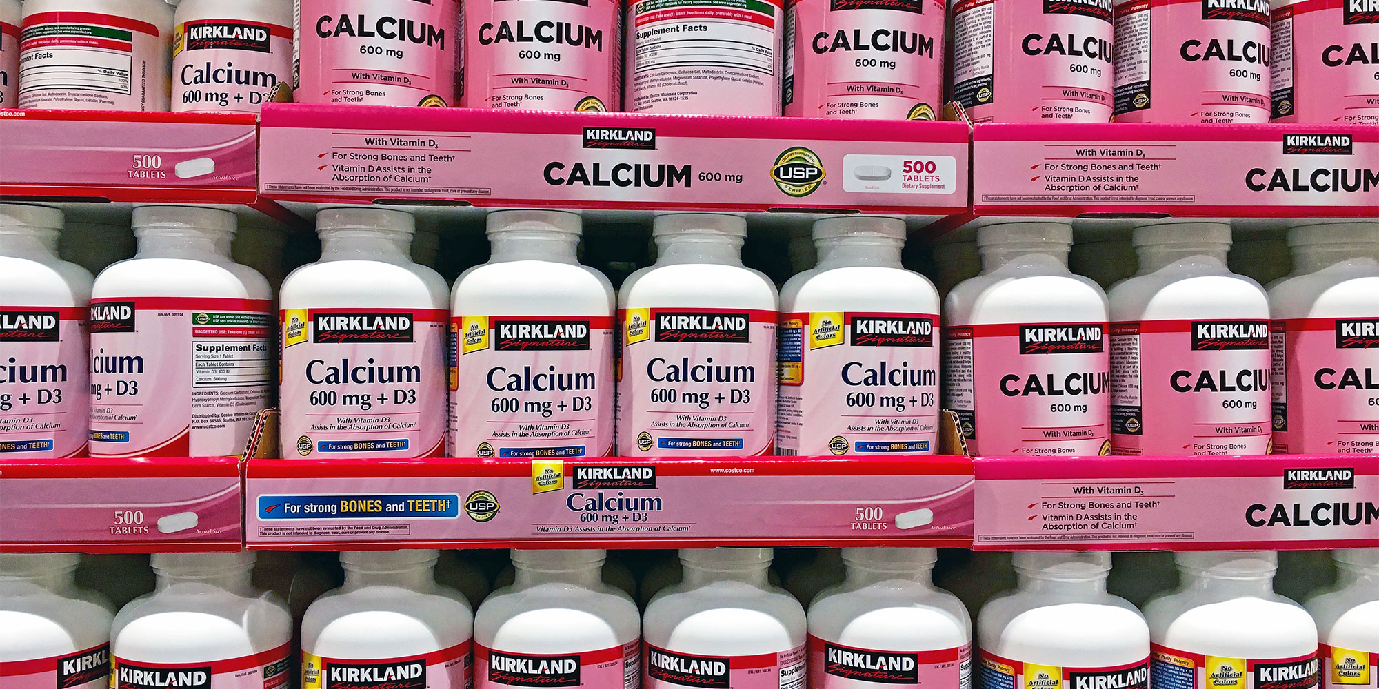 Bottles of calcium supplement on a shelf in a store