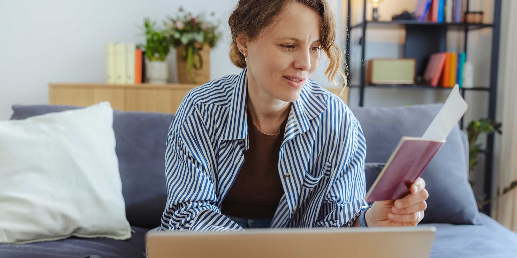 Woman calculating costs of flights with notebook