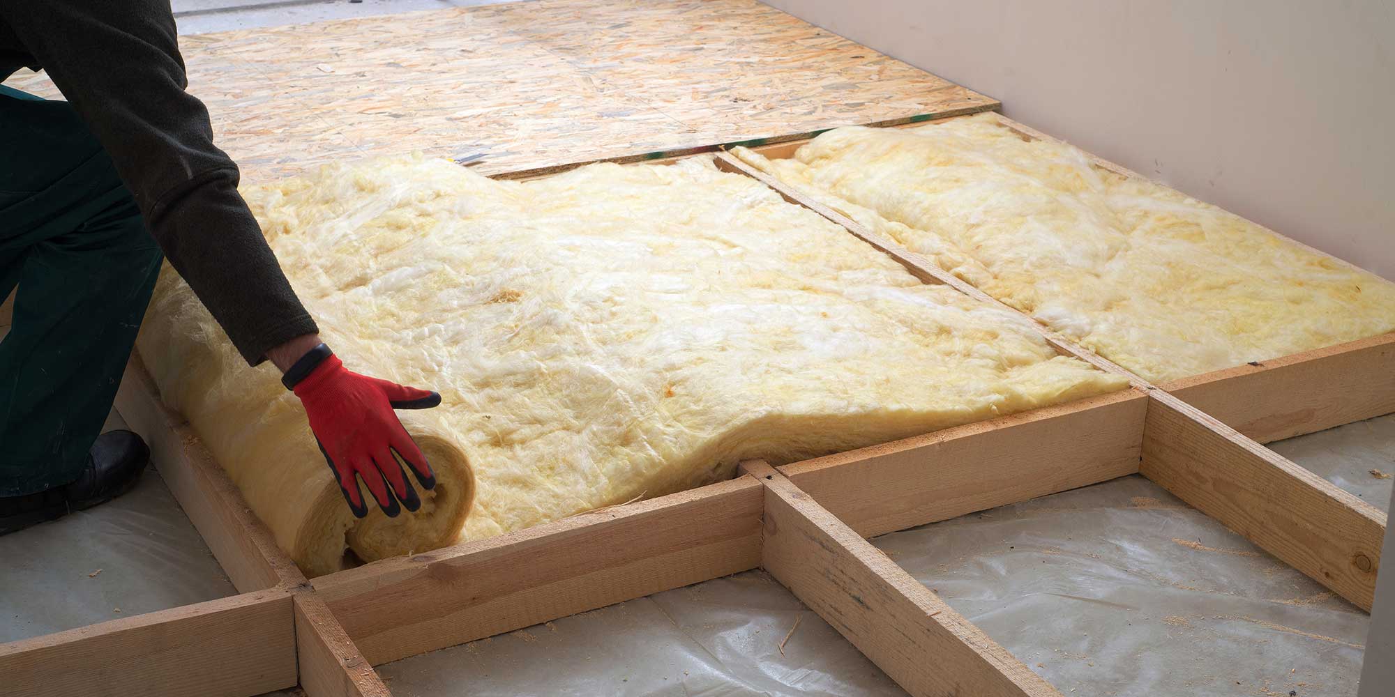 Tradesperson installing loft insulation