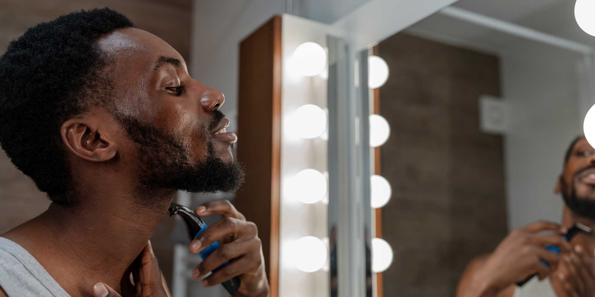 person using an electric shaver
