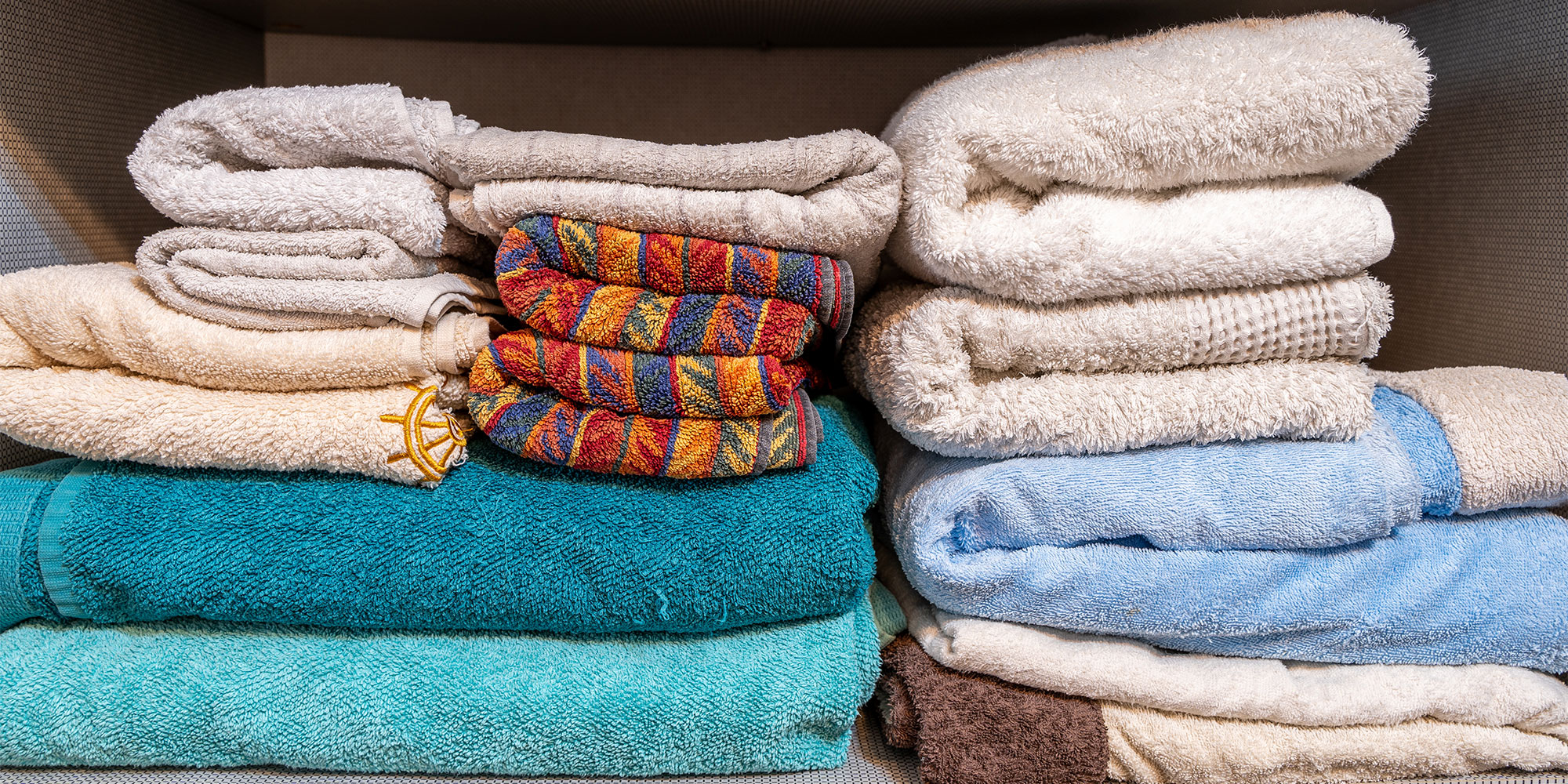 Pile of towels in cupboard