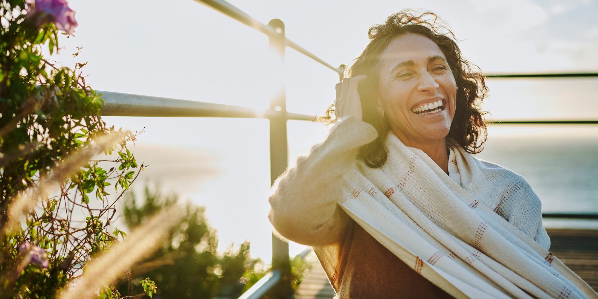 Mid life menopause woman in sunshine feeling happy
