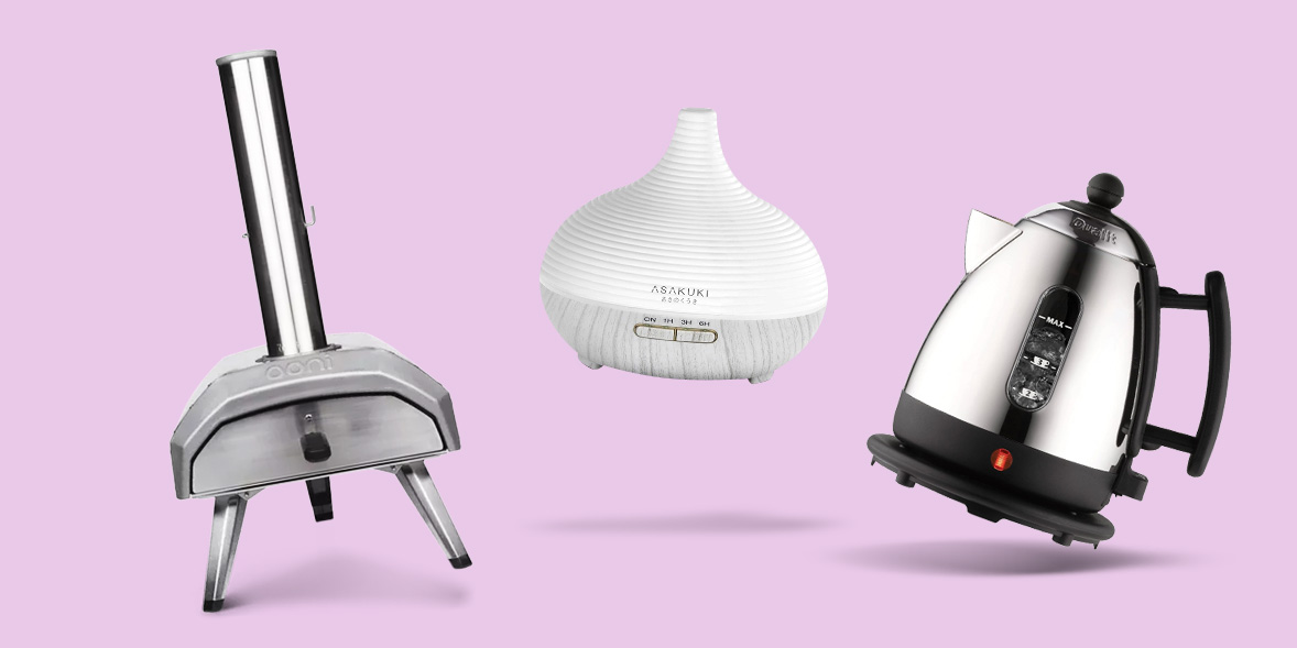 Pizza oven, scented oil diffuser and kettle on pink background