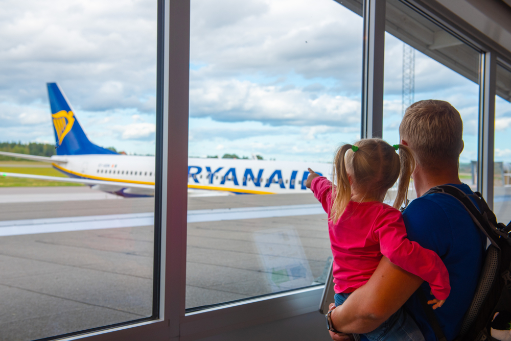Child pointing at Ryanair aircraft on tarmac