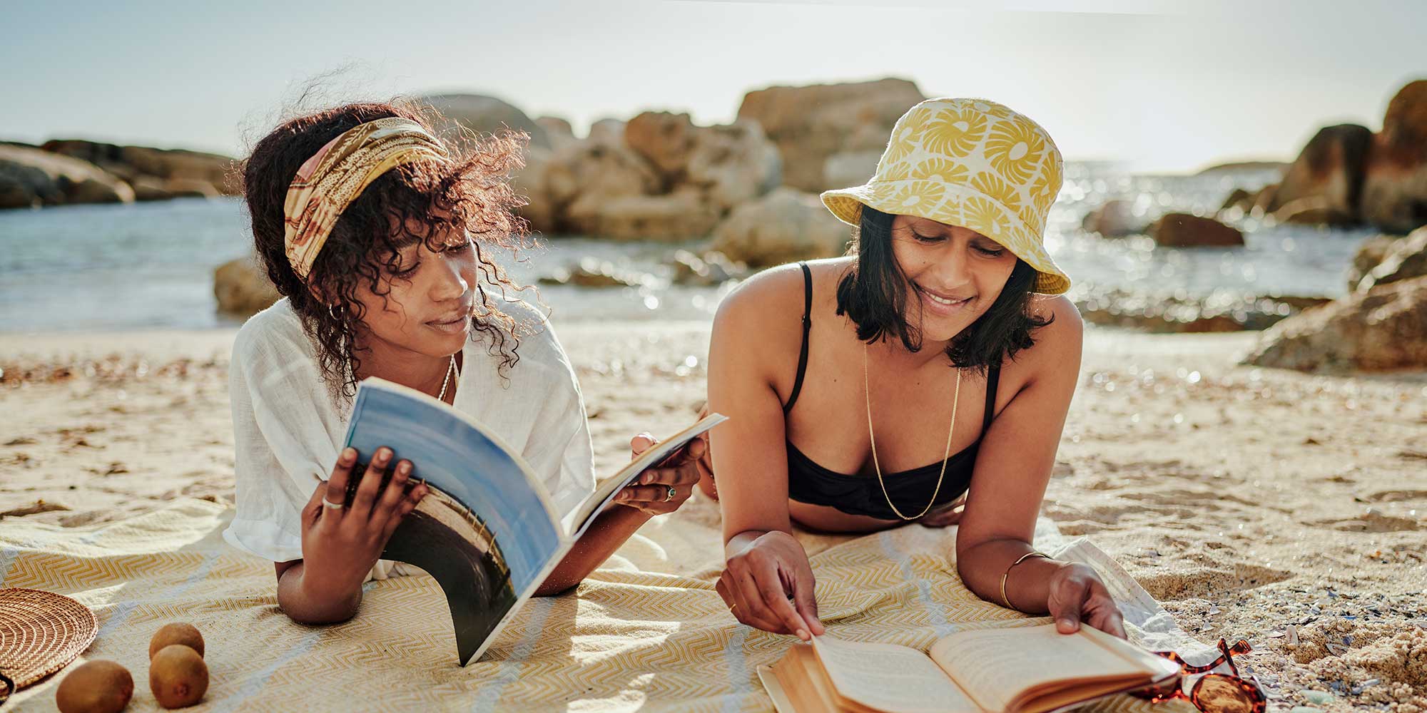 Two women sun-bathing on a beach