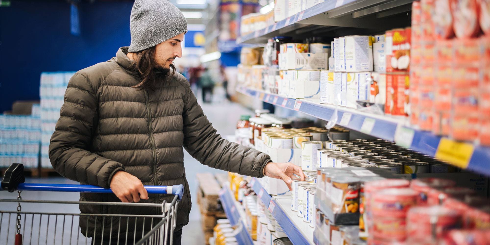 Man shopping for tinned foods