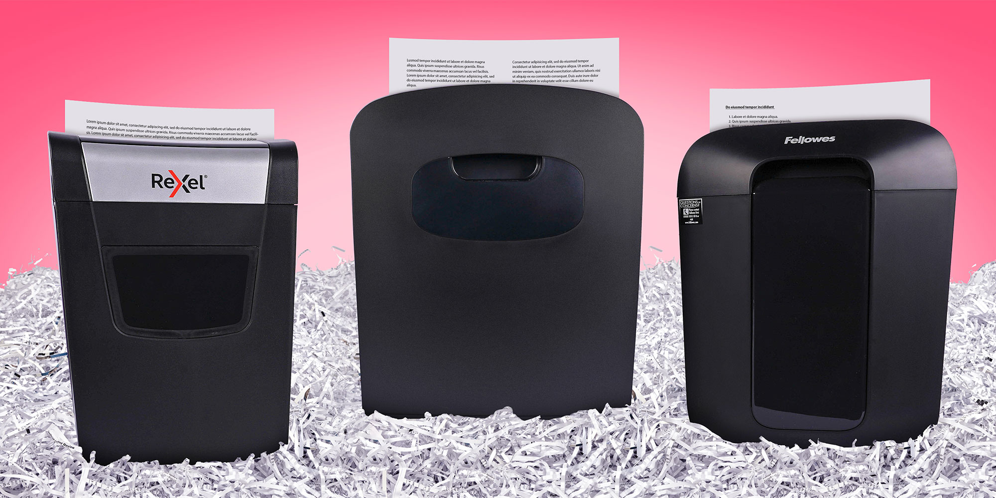 Three shredders lined up in a sea of shredded paper
