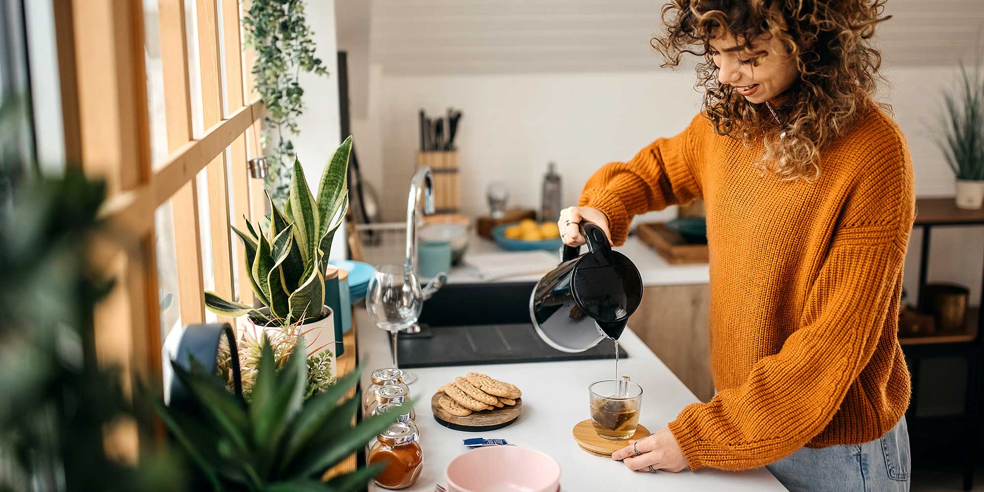 Person pouring a kettle in their kitchen