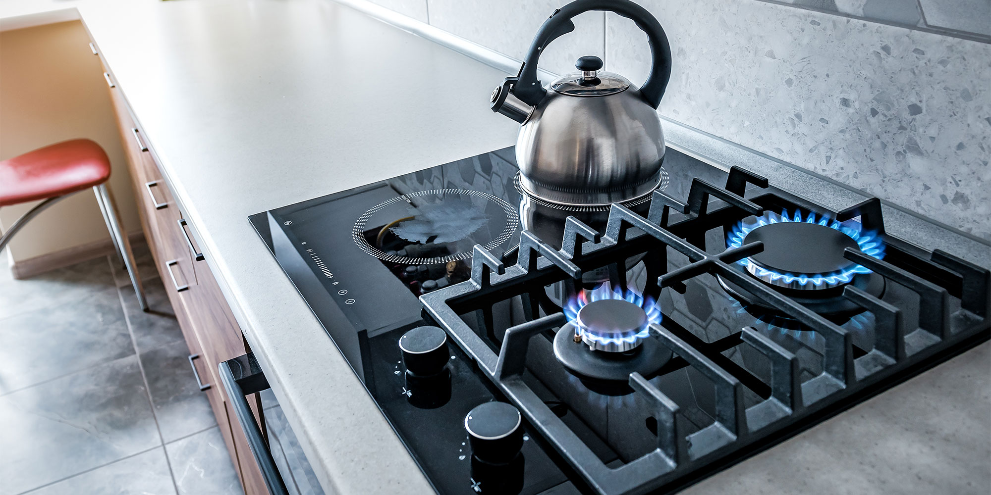 Dual fuel hob with gas and electric cooking zones