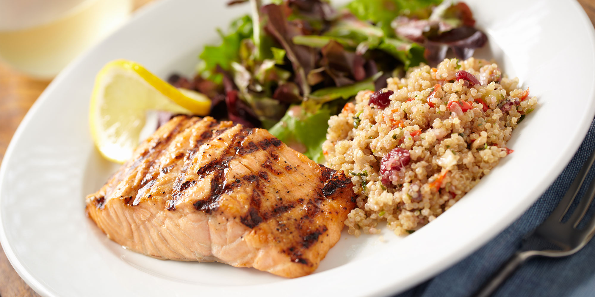A healthy meal of salmon with quinoa and salad