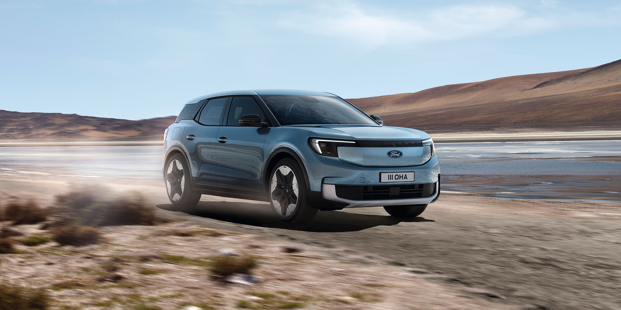 A blue Ford Explorer EV being driven on a dusty track