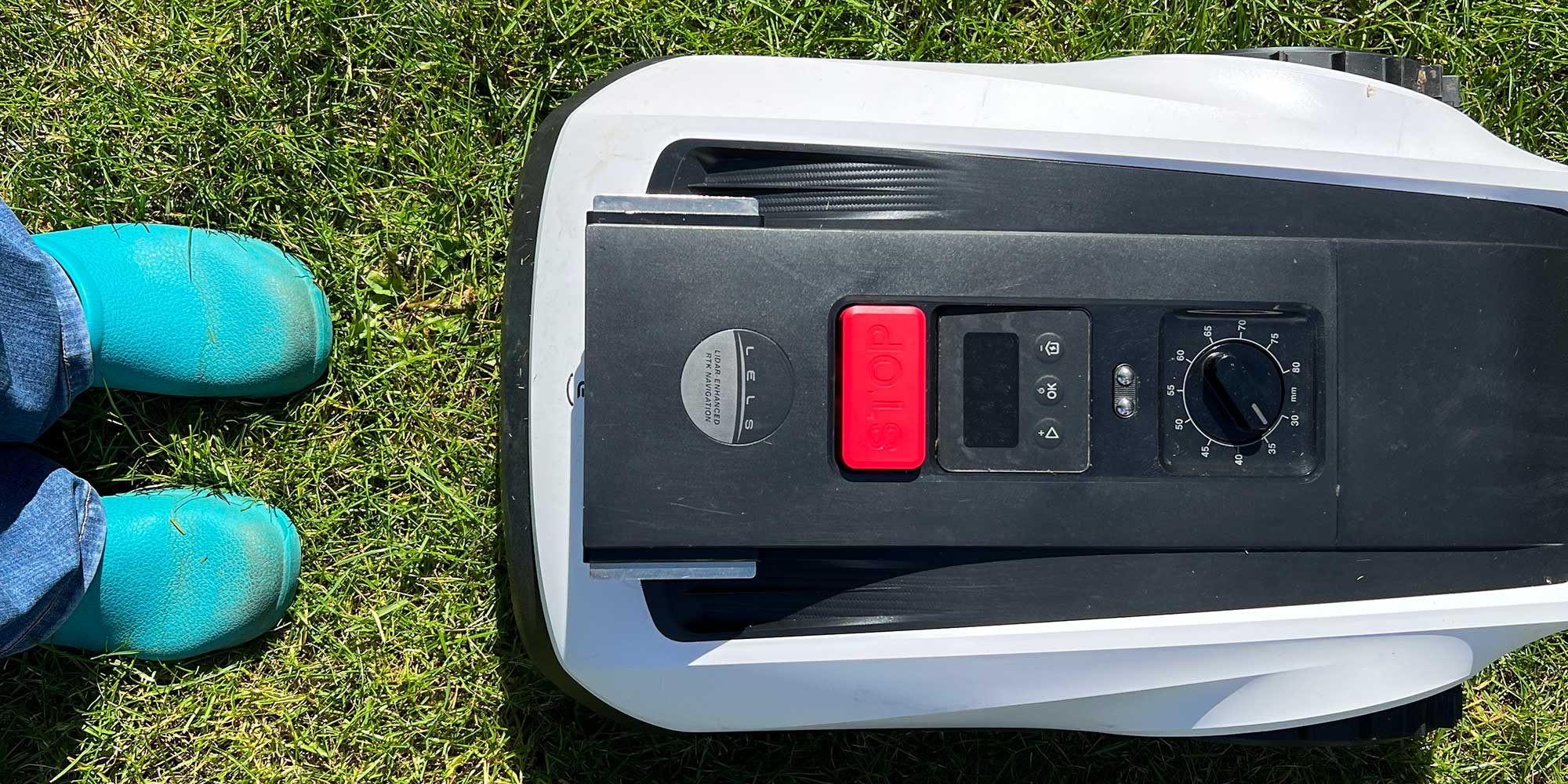 Robot lawnmower approaching feet