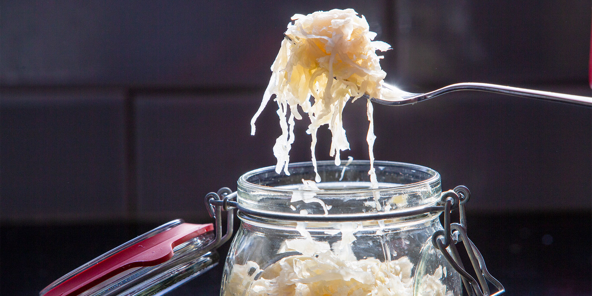 Sauerkraut piled on a fork from the jar 