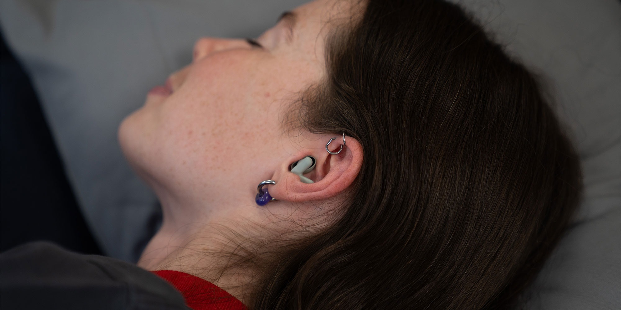 Which? tester tries out ear plugs while lying down