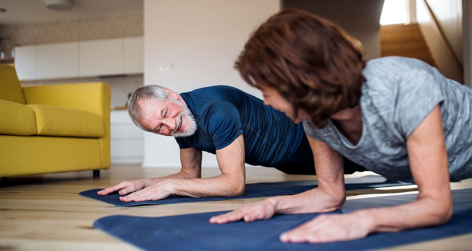 Man and woman exercising on mats
