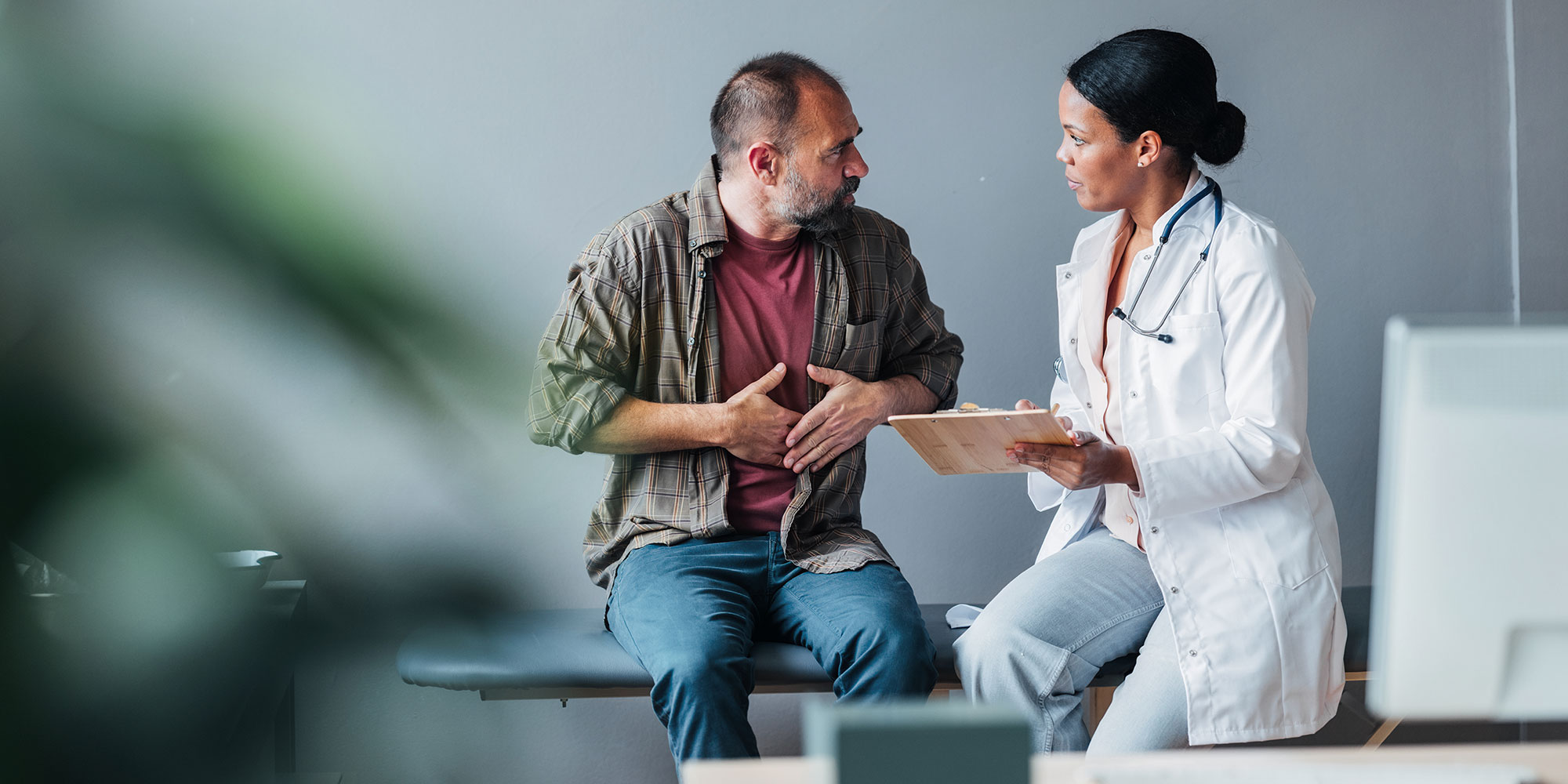 Man talking to a doctor about stomach issues