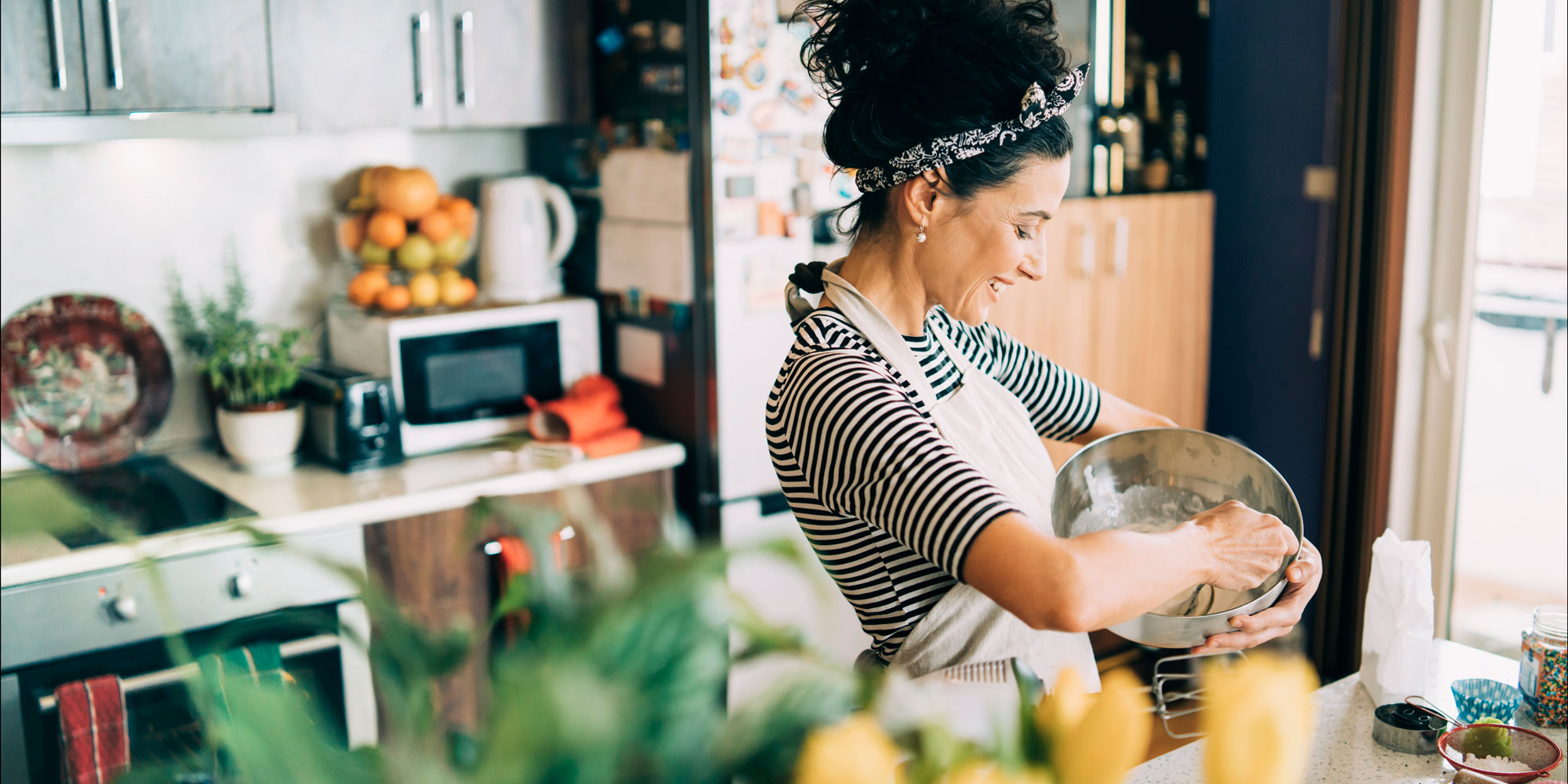 woman with a mixing bowl, baking in the kitchen