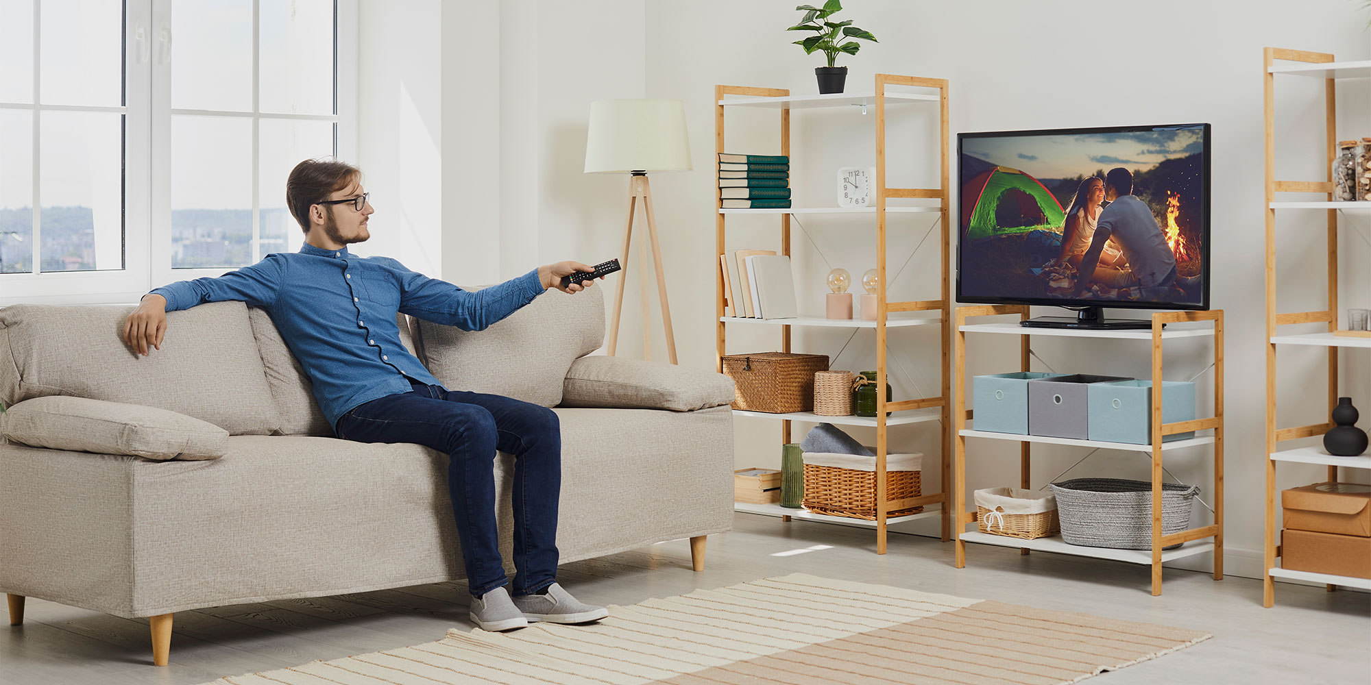 A man watches his TV at a 45-degree angle