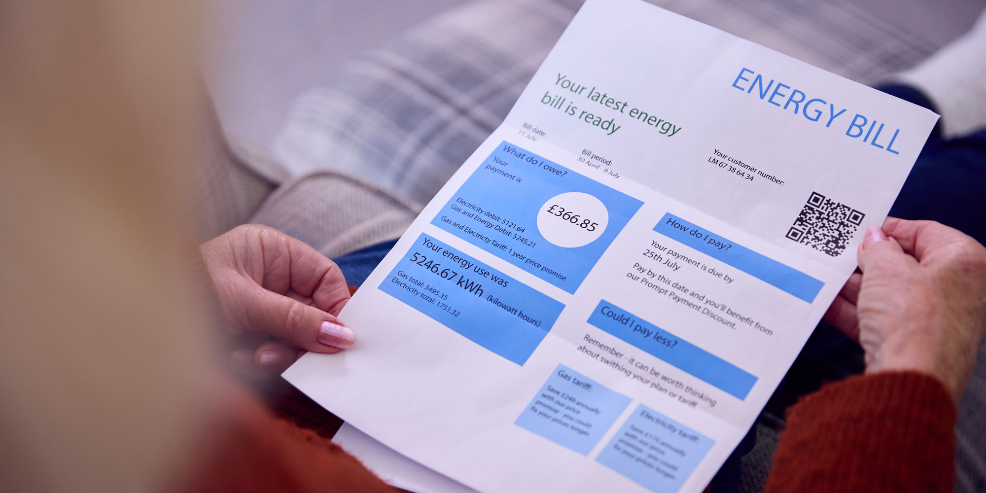 A person holding and looking at an energy bill