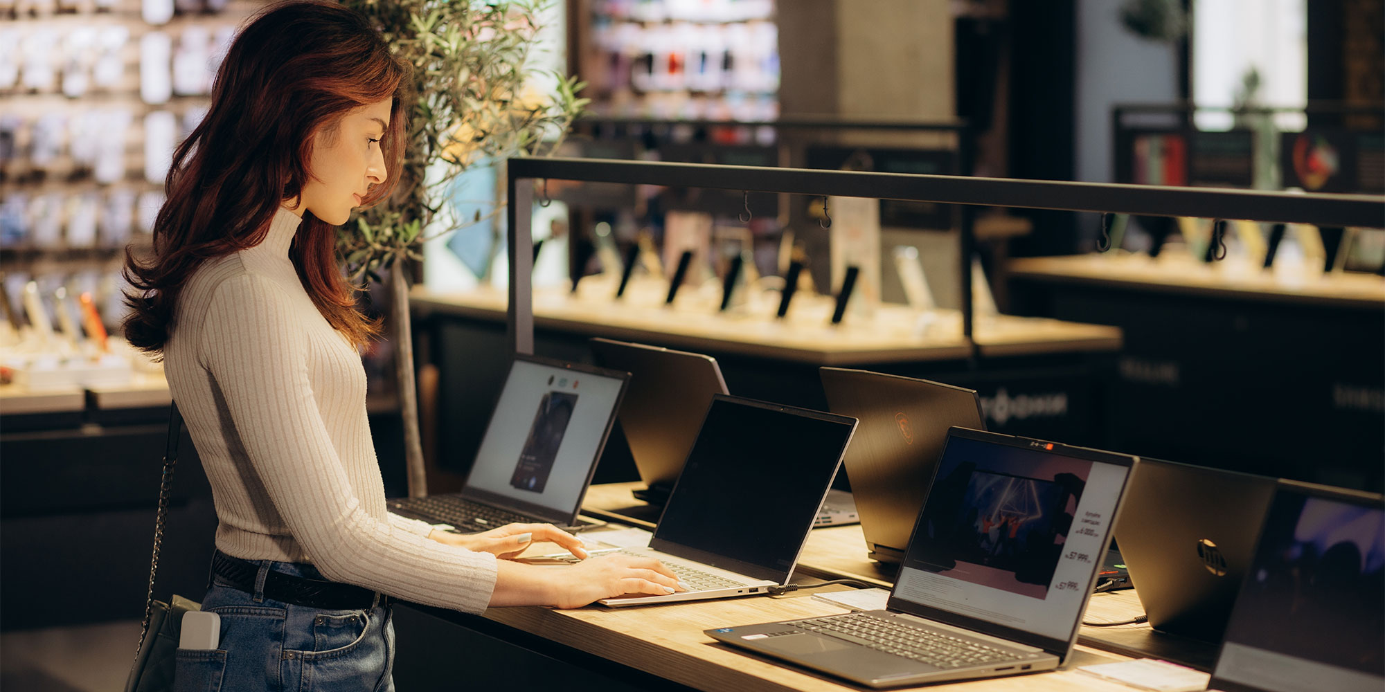 A woman shopping for laptops