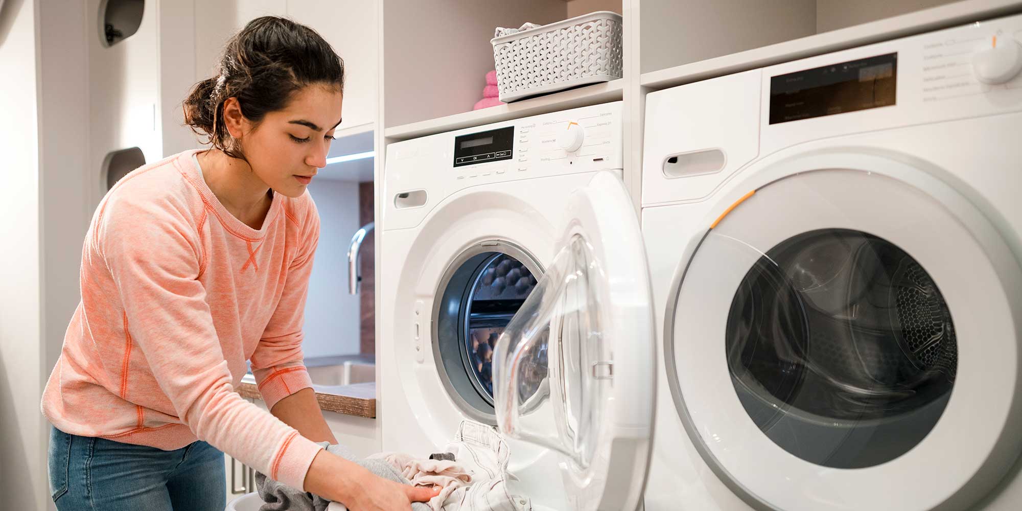 Woman unloading tumble dryer