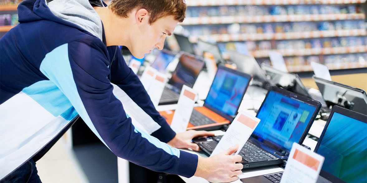 Man browsing for a laptop in a shop